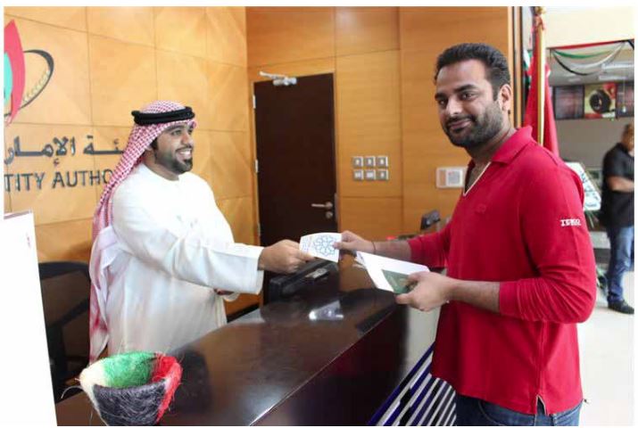 Ajman Center Employees Gift out ‘EXPO 2020’ Pins to Customers