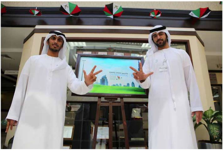 Ajman Center Employees Gift out ‘EXPO 2020’ Pins to Customers